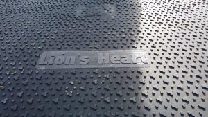 Na obrazie widoczna jest gumowa matka z nazwą Lion's Heart wytłoczoną na powierzchni w kształcie serc.